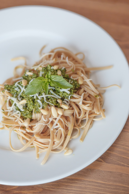 Homemade pesto sauce recipe. Whole wheat pasta noodles with basil pesto sauce, pine nuts, and parmesan cheese.