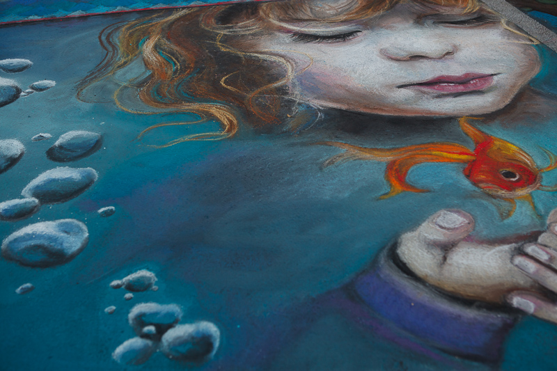 Girl holding a goldfish chalk art at Chalk The Block 2012 in Provo, UT