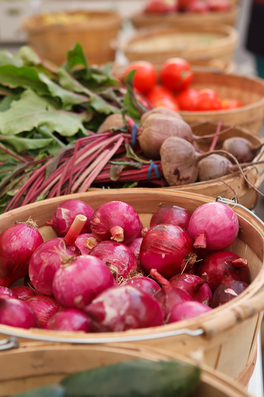 Red onions and beets in bushel baskets at the Provo Fresh Wednesday Farmer's Market in Downtown Provo