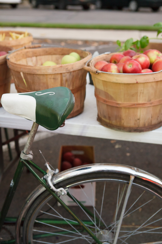 Bicycle and apples in bushel baskets at the Provo Fresh Wednesday Farmer's Market in Downtown Provo