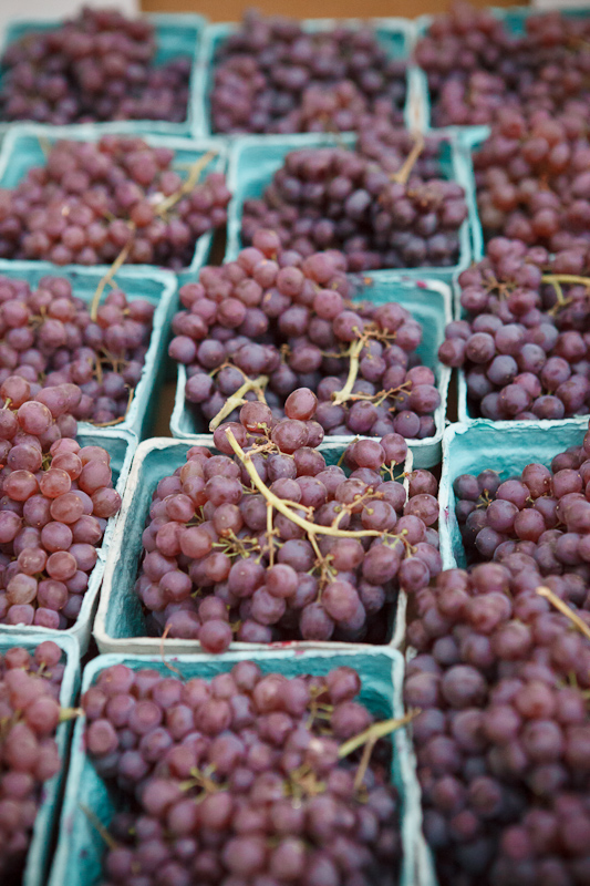 Baskets of red grapes at the Provo Fresh Wednesday Farmer's Market in Downtown Provo